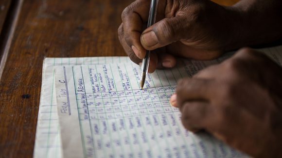 An eye health worker filling in paperwork.