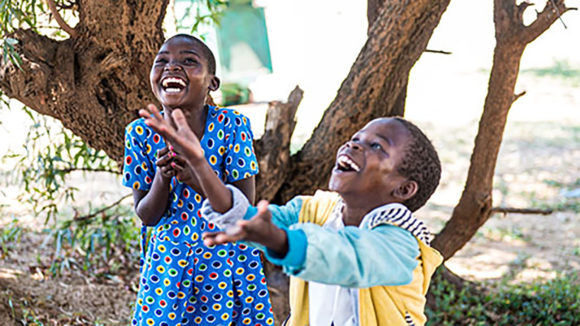 Taonga and Mary play happily outside.