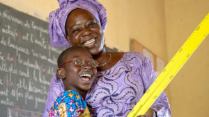 Mafoune and her teacher smiling.
