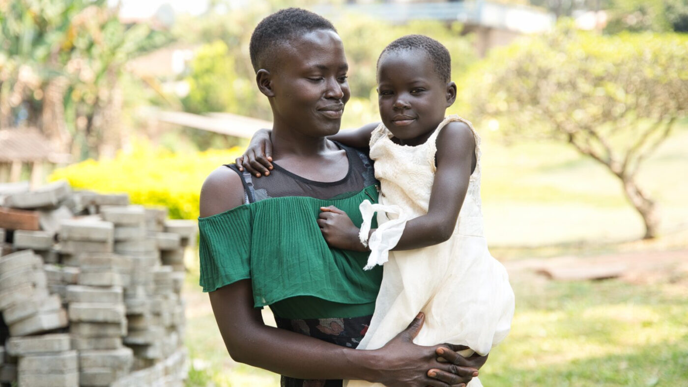 Happy holdes av et familiemedlem, smilende.